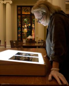 A person looking at art on a monitor.