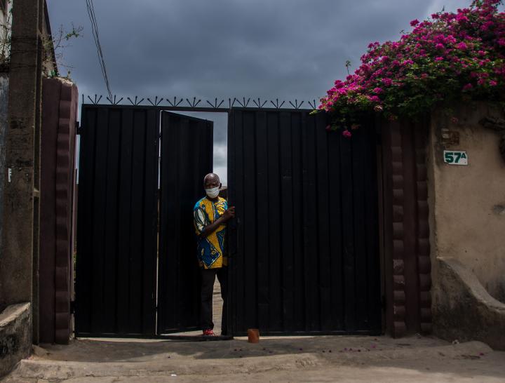 Man opening a front gate