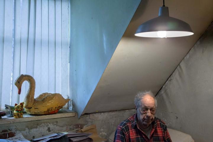 Photo of an old man in his apartment