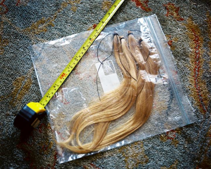 Measuring tape with hair in a zip block bag 