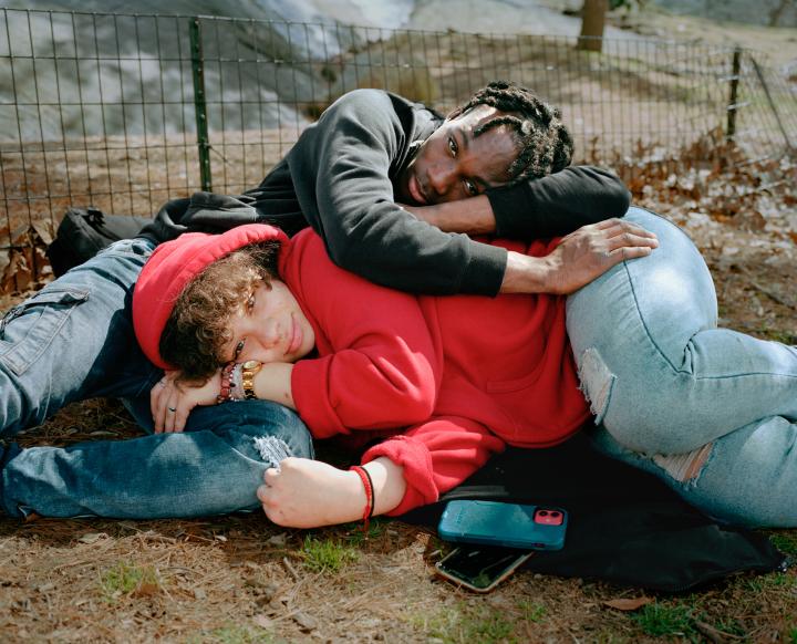 Two people on the floor huddled together